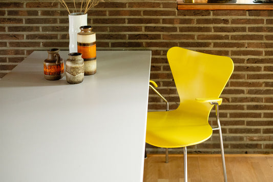 Six bright yellow Butterfly chairs in the style of Fritz Hansen